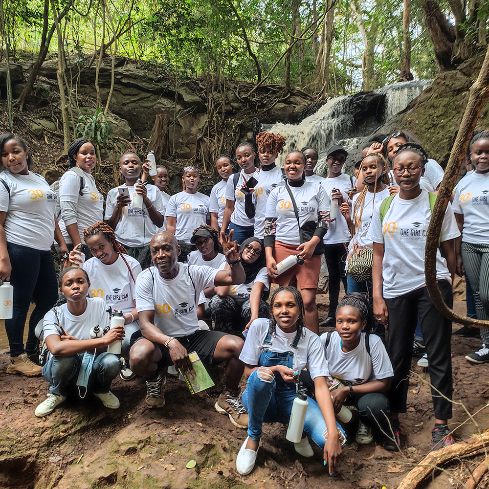 group photo of students and daniel in forest on walk